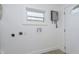 Bright laundry area with a window, fresh paint, and modern water heater at 109 S 10Th S Ave, Beech Grove, IN 46107