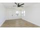 Bright living room featuring light colored floors, white walls, and a modern ceiling fan at 109 S 10Th S Ave, Beech Grove, IN 46107