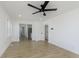 Bright living room featuring light colored floors, white walls, and a modern ceiling fan at 109 S 10Th S Ave, Beech Grove, IN 46107