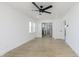 Bright living room featuring light colored floors, white walls, and a modern ceiling fan at 109 S 10Th S Ave, Beech Grove, IN 46107