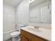 Clean bathroom with a tub and shower, vanity, mirror, and toilet at 10905 Amber Glow Ln, Indianapolis, IN 46229