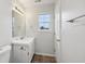 Bathroom features a window, neutral walls, updated vanity, and tile floor at 10905 Amber Glow Ln, Indianapolis, IN 46229