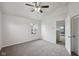 Bright bedroom showcasing neutral carpet and walls, ceiling fan, and doorway at 10905 Amber Glow Ln, Indianapolis, IN 46229