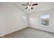 Well-lit bedroom featuring neutral walls, ceiling fan, and two windows at 10905 Amber Glow Ln, Indianapolis, IN 46229