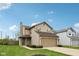 Charming two-story home features a two-car garage, green shutters, tidy landscaping and a well-maintained lawn at 10905 Amber Glow Ln, Indianapolis, IN 46229