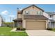 Charming two-story home features a two-car garage, green shutters, tidy landscaping and a well-maintained lawn at 10905 Amber Glow Ln, Indianapolis, IN 46229