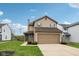 Charming two-story home features a two-car garage, green shutters, tidy landscaping and a well-maintained lawn at 10905 Amber Glow Ln, Indianapolis, IN 46229