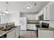 Kitchen featuring granite countertops, stainless appliances, double sink, and bright white cabinets at 10905 Amber Glow Ln, Indianapolis, IN 46229