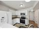 Updated kitchen with stainless steel appliances, granite countertops, and white cabinetry at 10905 Amber Glow Ln, Indianapolis, IN 46229
