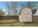 Storage shed in a fenced backyard with mature trees at 10905 Amber Glow Ln, Indianapolis, IN 46229