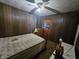 Bedroom with wood paneled walls and a ceiling fan at 1152 W 375 N, Anderson, IN 46011
