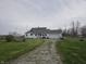 Quaint single-story home with an attached garage and large front yard at 1152 W 375 N, Anderson, IN 46011