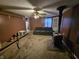 Cozy living room featuring a ceiling fan, wood-burning stove, and comfortable seating for relaxing evenings at 1152 W 375 N, Anderson, IN 46011