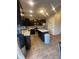 Open kitchen with island, stainless steel appliances, dark wood cabinets and granite countertops at 11726 Zander Dr, Indianapolis, IN 46235