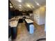 Open kitchen with island, stainless steel appliances, dark wood cabinets and granite countertops at 11726 Zander Dr, Indianapolis, IN 46235
