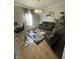 Living room featuring natural light and furnishings including a recliner set and glass desk at 11726 Zander Dr, Indianapolis, IN 46235