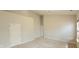 A large bedroom with neutral carpet, fresh paint, and a hallway entrance at 13648 Seven Oaks Dr, Fishers, IN 46038