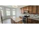 Stylish kitchen featuring granite countertops, stainless steel appliances, tiled backsplash, and hardwood floors at 13648 Seven Oaks Dr, Fishers, IN 46038