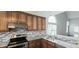 Modern kitchen showcasing granite countertops, stainless steel appliances, and ample cabinet space at 13648 Seven Oaks Dr, Fishers, IN 46038