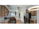 Spacious kitchen featuring granite countertops, stainless steel appliances, modern lighting, and hardwood floors at 13648 Seven Oaks Dr, Fishers, IN 46038