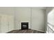 A living room showing a fireplace, hardwood floors, closet, and a window at 13648 Seven Oaks Dr, Fishers, IN 46038
