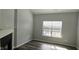 Cozy living room features a fireplace, hardwood floors, and a sunlit window at 13648 Seven Oaks Dr, Fishers, IN 46038