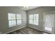 Cozy sunroom with hardwood floors, multiple windows offering views, and a walk-out door at 13648 Seven Oaks Dr, Fishers, IN 46038