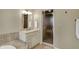 Neutral bathroom showcases vanity with sink, mirror, and glass enclosed shower stall at 13682 Frenchmans Creek, Carmel, IN 46032