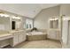 Luxurious bathroom with a large soaking tub, dual vanities, and elegant fixtures at 13682 Frenchmans Creek, Carmel, IN 46032