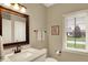 Elegant bathroom with marble vanity, classic fixtures, and a bright window view at 13682 Frenchmans Creek, Carmel, IN 46032