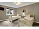 Bedroom with two twin beds, neutral walls, carpeted floor, dark trim and a window with a view at 13682 Frenchmans Creek, Carmel, IN 46032
