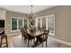 Dining room features a rustic wooden table, a chandelier, and large windows overlooking the backyard at 13682 Frenchmans Creek, Carmel, IN 46032