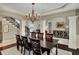 Elegant dining room with hardwood floors, modern chandelier, and plenty of seating space at 13682 Frenchmans Creek, Carmel, IN 46032
