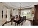 Formal dining room with a large table, chandelier, and view of the landscaped front yard at 13682 Frenchmans Creek, Carmel, IN 46032