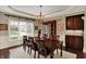 Formal dining area with hardwood floors, modern lighting, and a built-in cabinet at 13682 Frenchmans Creek, Carmel, IN 46032