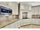 Well-lit kitchen with white cabinetry, granite countertops, and stainless steel microwave at 13682 Frenchmans Creek, Carmel, IN 46032