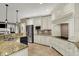 Well-lit kitchen features granite countertops, stainless steel appliances, and custom cabinetry at 13682 Frenchmans Creek, Carmel, IN 46032