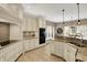 Bright kitchen featuring white cabinetry, granite countertops, and stainless steel appliances at 13682 Frenchmans Creek, Carmel, IN 46032