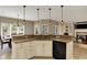 Spacious kitchen with a large island, pendant lighting, and open view to the dining area at 13682 Frenchmans Creek, Carmel, IN 46032