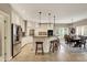 Open kitchen with a spacious island, stainless steel appliances, and adjacent dining area at 13682 Frenchmans Creek, Carmel, IN 46032