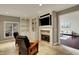 Inviting living room with stone fireplace, built-in shelving, and open doorway at 13682 Frenchmans Creek, Carmel, IN 46032