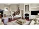 Open concept living room with a fireplace and staircase, with view of dining area and entrance at 13682 Frenchmans Creek, Carmel, IN 46032