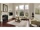 Bright living room featuring a fireplace, large windows, and comfortable seating at 13682 Frenchmans Creek, Carmel, IN 46032
