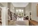 Bright living room featuring a fireplace, large windows, and hardwood floors at 13682 Frenchmans Creek, Carmel, IN 46032