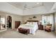 Cozy main bedroom with a tray ceiling, comfortable seating, and a walk-in closet at 13682 Frenchmans Creek, Carmel, IN 46032
