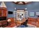 Office with custom millwork, a sailboat figurine, and an adjacent living room through French doors at 13682 Frenchmans Creek, Carmel, IN 46032