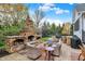 Backyard patio featuring a custom stone fireplace and outdoor seating, ideal for gatherings and relaxation at 13682 Frenchmans Creek, Carmel, IN 46032