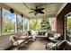 Screened in porch with ceiling fan, and comfortable furniture, perfect for enjoying the outdoor view at 13682 Frenchmans Creek, Carmel, IN 46032