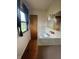 Bathroom with a window, sink, and decorative mirror offering natural light and space for personalization at 1387 W Furry Rd, Fountaintown, IN 46130
