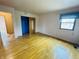 A sunny bedroom features hardwood flooring, a closet with a mirror, and a window at 1387 W Furry Rd, Fountaintown, IN 46130